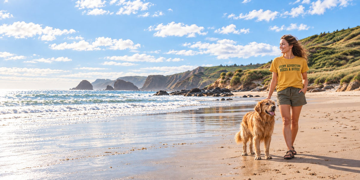 A Buddy Outfitters tee and a golden retriever on the beach